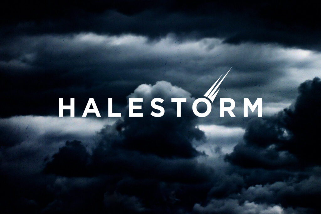 Dark stormy clouds with the word 'Halestorm' in bold white text and a stylised lightning bolt incorporated into the letter 'O'.