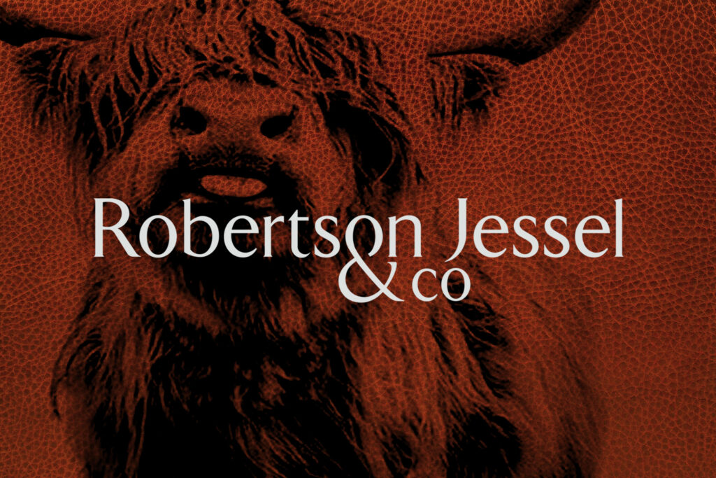 Close-up of a textured, red-toned image of a highland cow, with the text 'Robertson Jessel & co' overlaid in white.